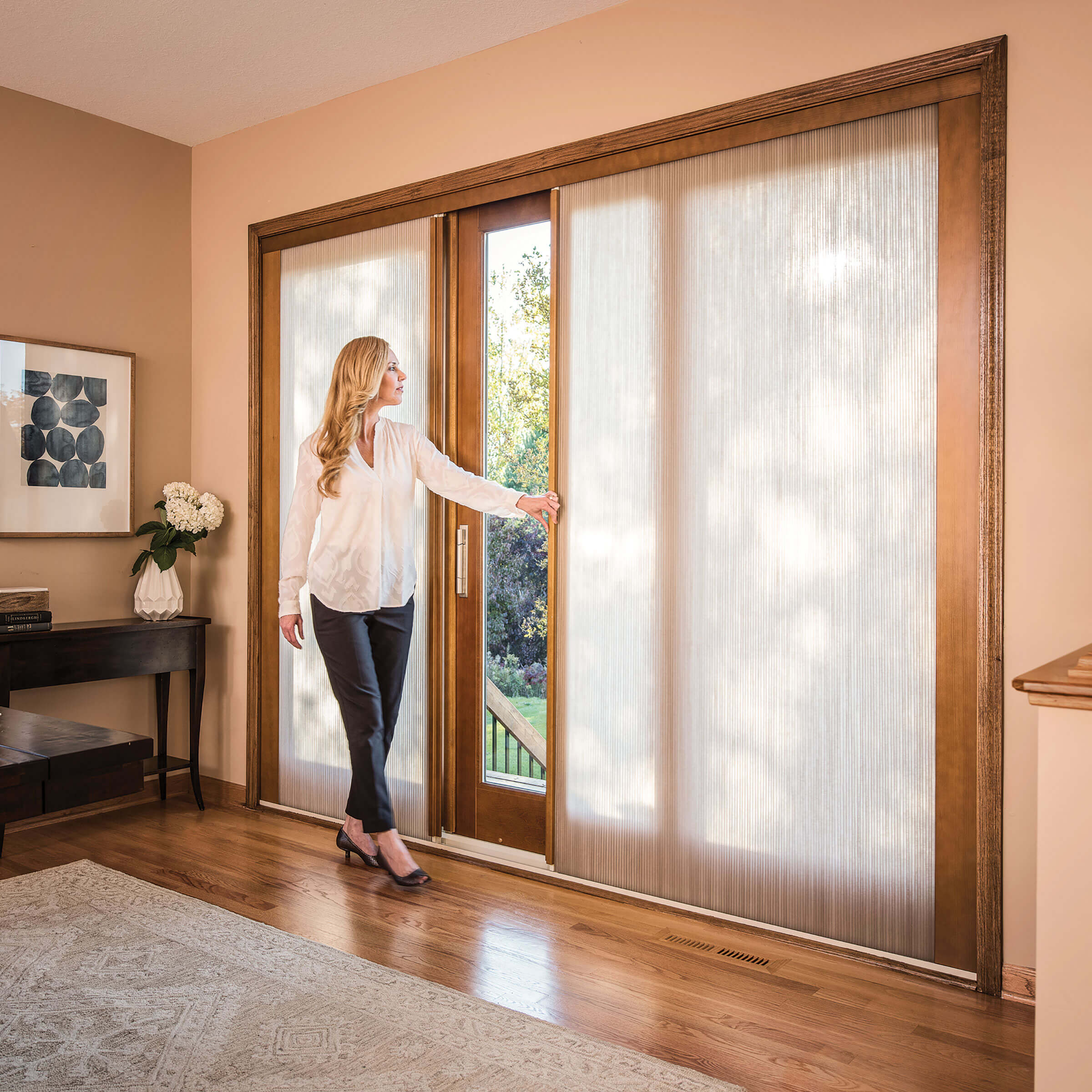 Woman Opening Signature Ultimate Sliding French Door With Shades 