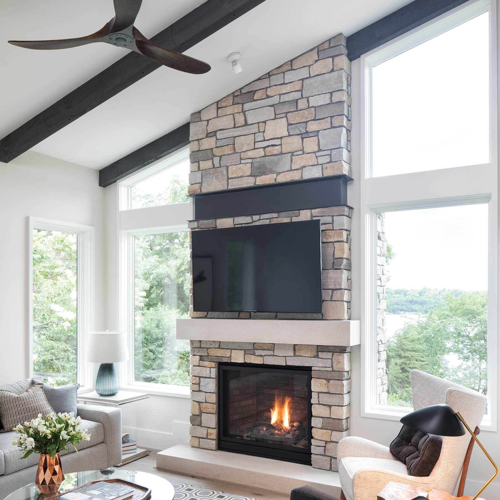 Living room with vaulted ceiling and exposed beams with Marvin Elevate Direct Glaze Windows, Elevate Casement Windows, Elevate Picture Windows and Elevate Specialty Shapes Windows