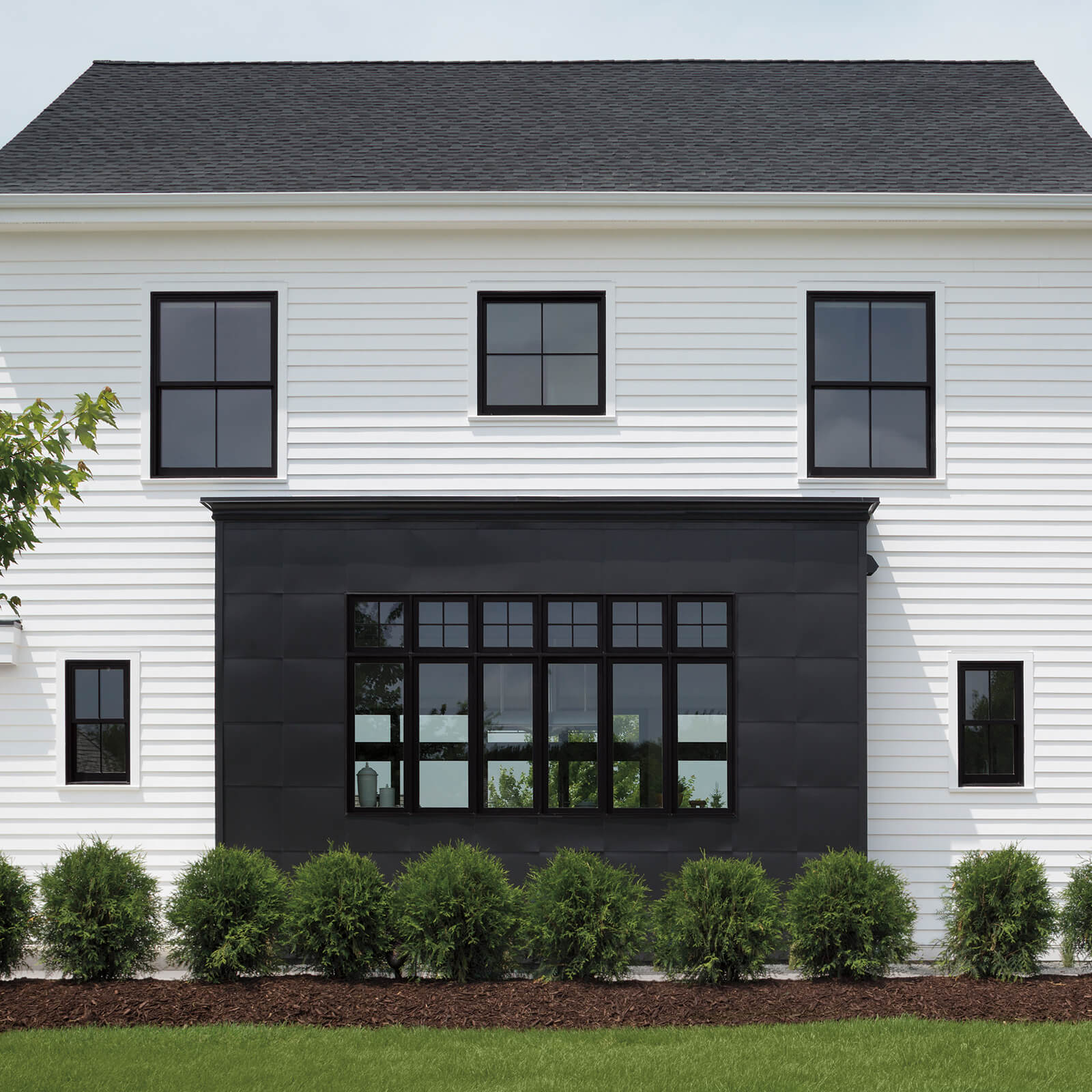 White, gray and black exterior home with Marvin Signature Ultimate Casement Windows and Ultimate Double Hung G2 Windows