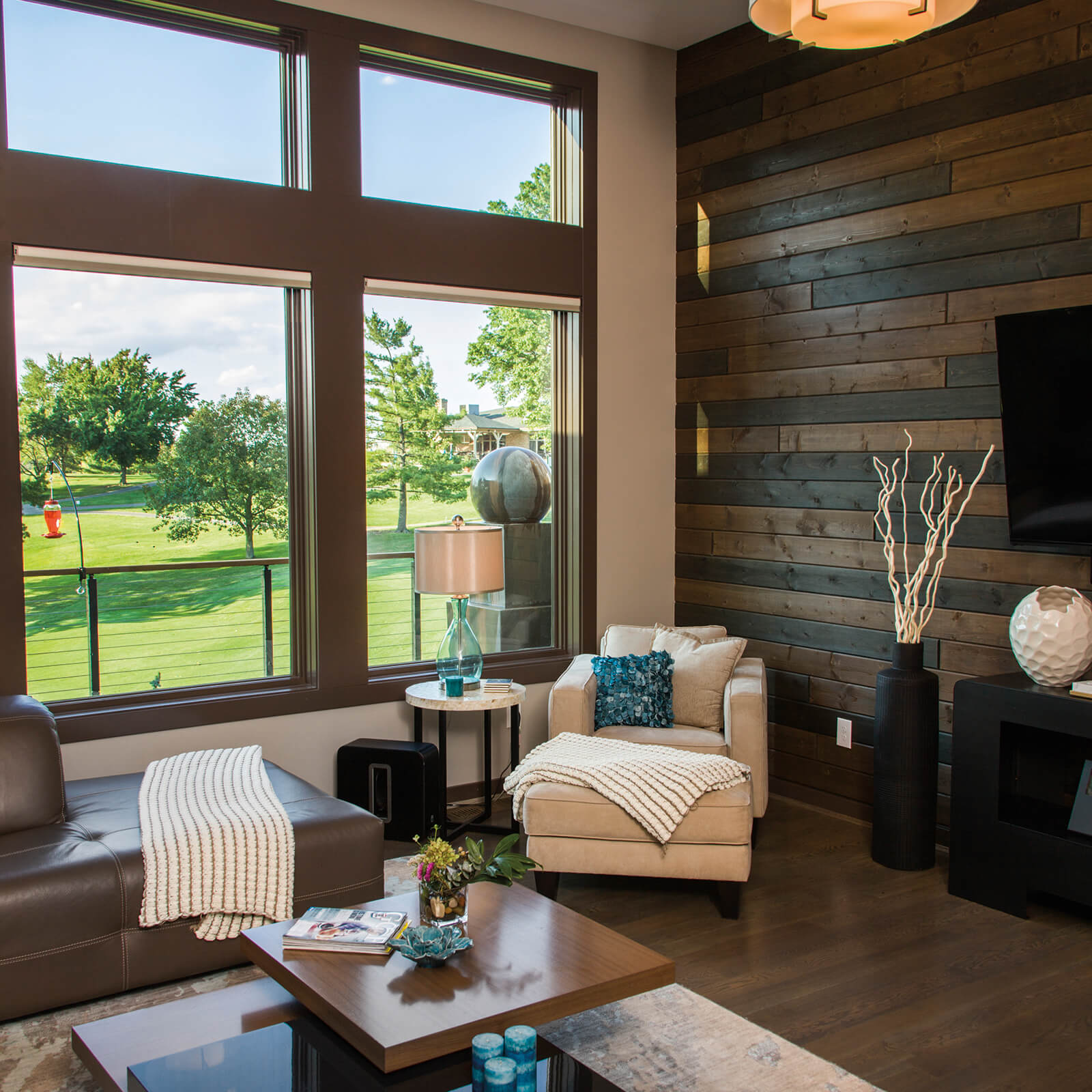 Modern style living room with wood paneling that features Marvin Elevate Picture Windows