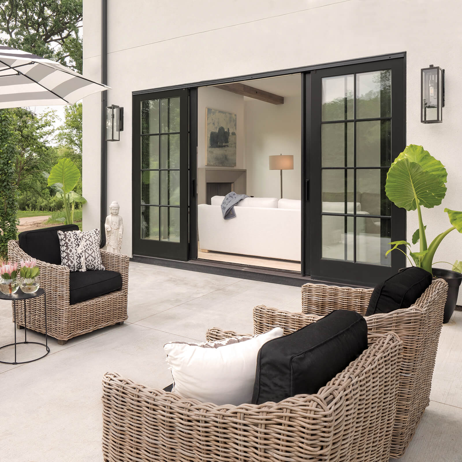 Patio entertainment area with open Marvin Signature Ultimate Sliding French Door