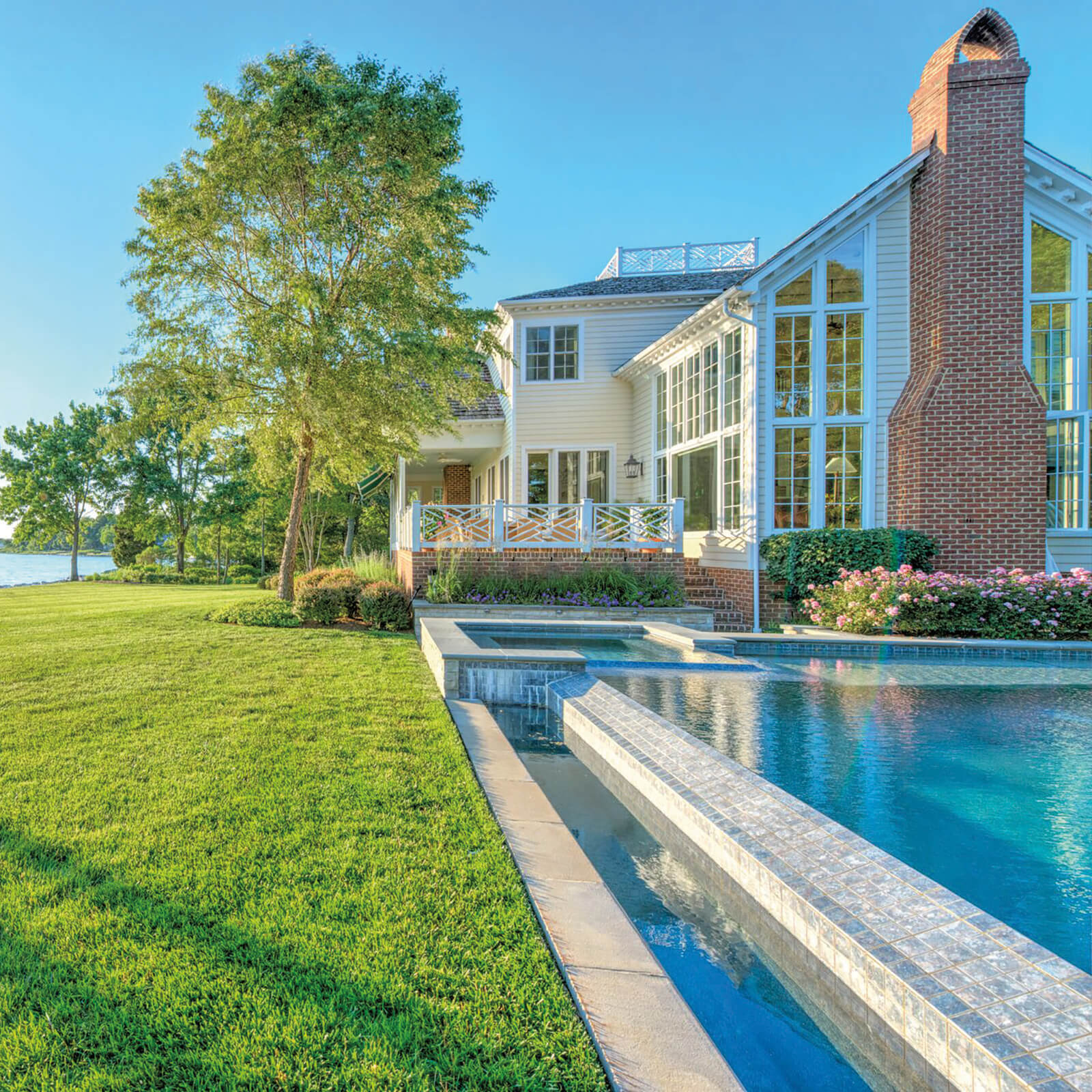 Poolside view of waterfront home with Marvin Elevate Inswing French Door