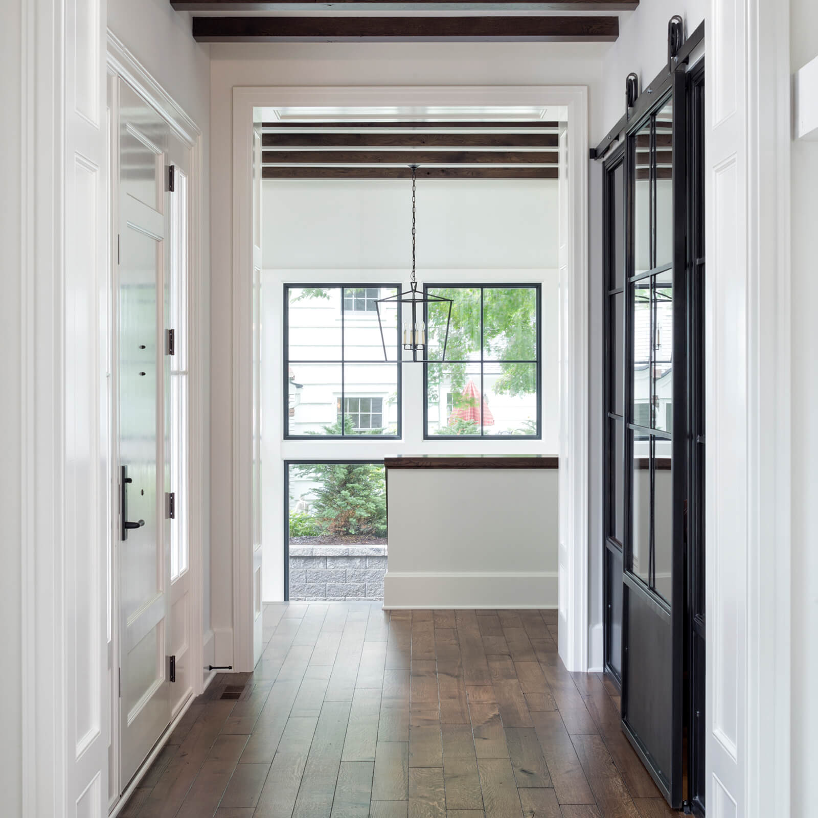 Interior hallway looking out to Marvin Signature Ultimate Casement Windows and Ultimate Picture Windows