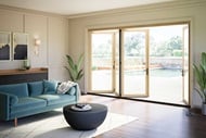 Living room with partially open Elevate Bi-Fold Door