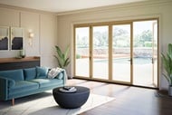 Living room with one panel open Elevate Bi-Fold Door