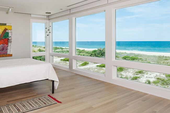 Bedroom With Beautiful Beach View Through Marvin Elevate Picture Windows