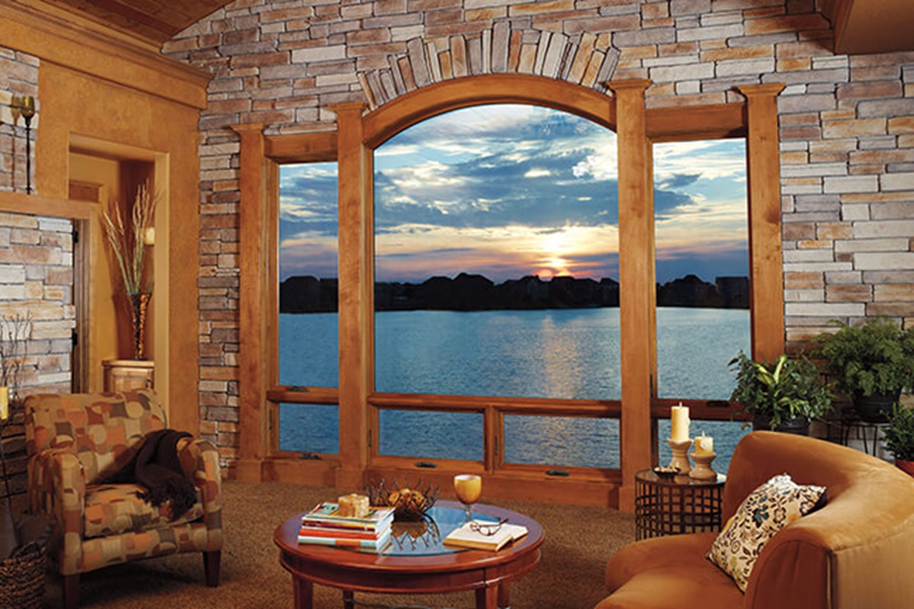Living Room With Sunset View Through A Marvin Elevate Round Top Window