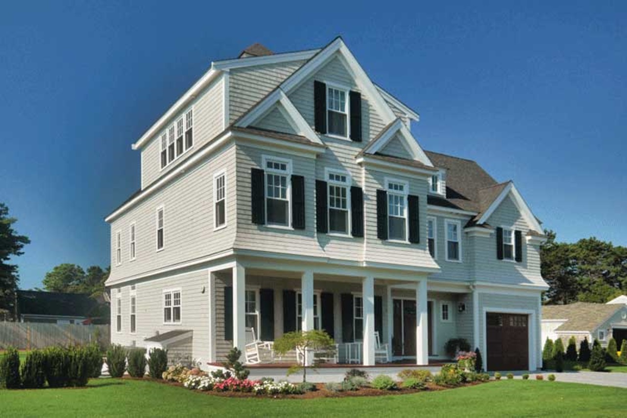 An exterior of a home featuring Marvin Essential double hung windows and an inswing french door