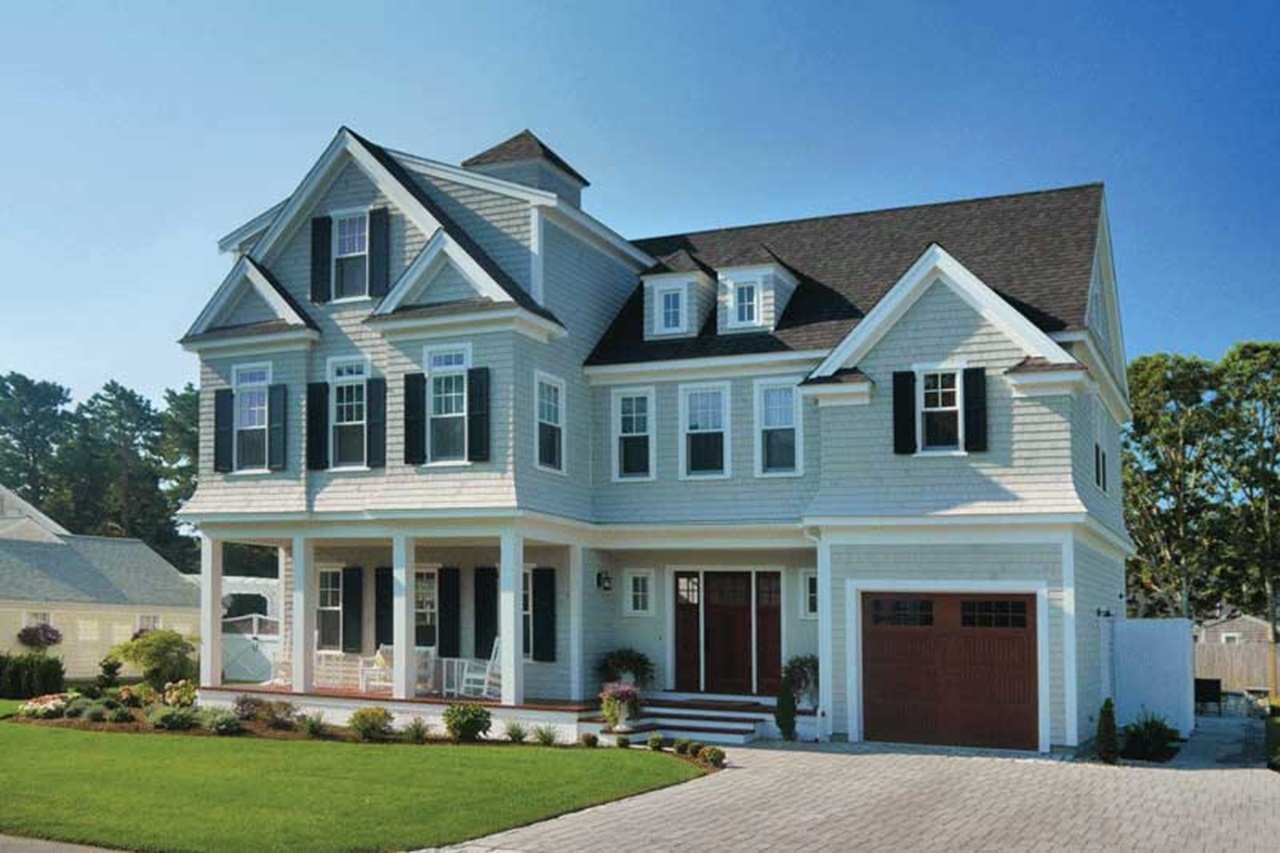 An exterior of a home featuring Marvin Essential double hung windows and an inswing french door