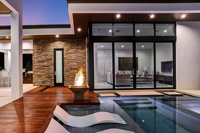 Outdoor space of home with pool and Marvin Signature Coastline windows and doors