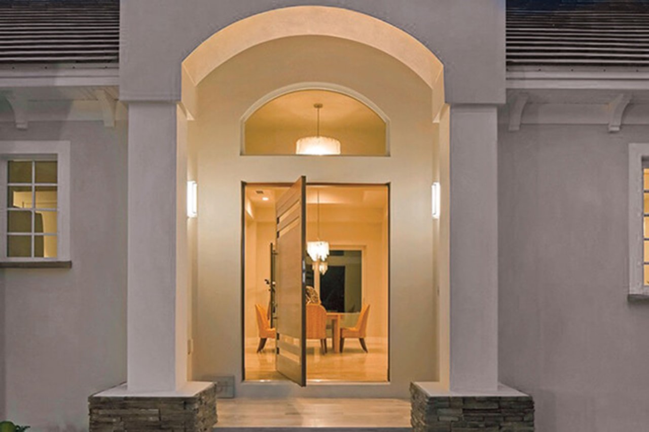 Entryway of home with Marvin Signature Coastline Casement window and Marvin Signature Coastline Pivot Door
