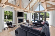 Living room with high ceilings with wood beams and fireplace