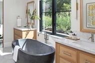 Bathroom with stone bathtub and modern casement windows