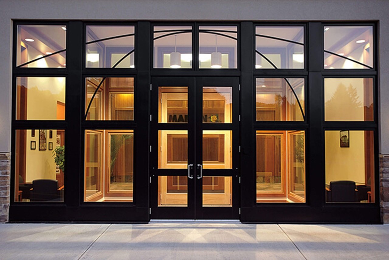 Exterior View of Brightly Lit Building With A Signature Ultimate Commercial Door
