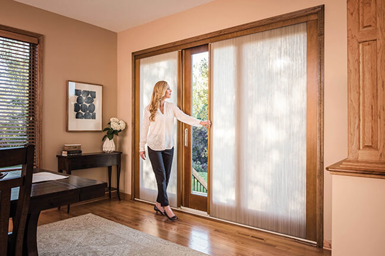Woman Opening Signature Ultimate Sliding French Door With Shades