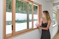Amber Strange in front of Marvin Ultimate Wood Glider Window