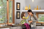 Mother And Daughter In Kitchen With Signature Ultimate Glider Window