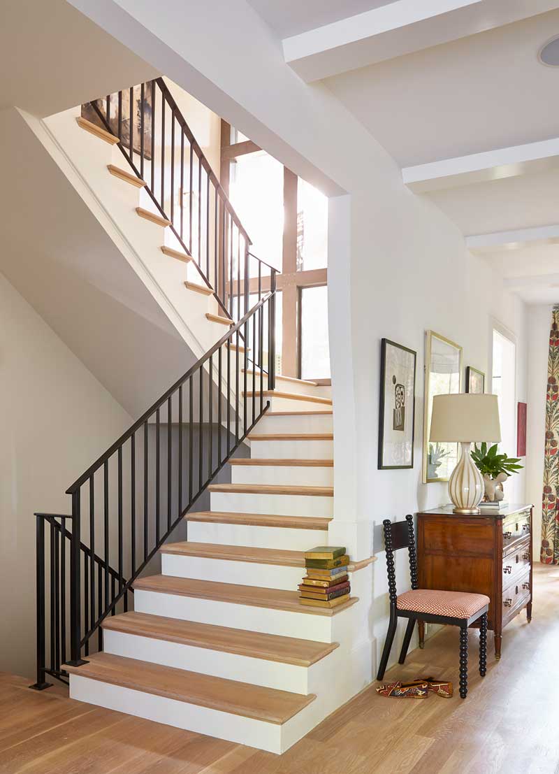 The staircase in the House Beautiful Whole Home 2018 in Atlanta, Georgia, featuring Marvin Ultimate Picture windows.