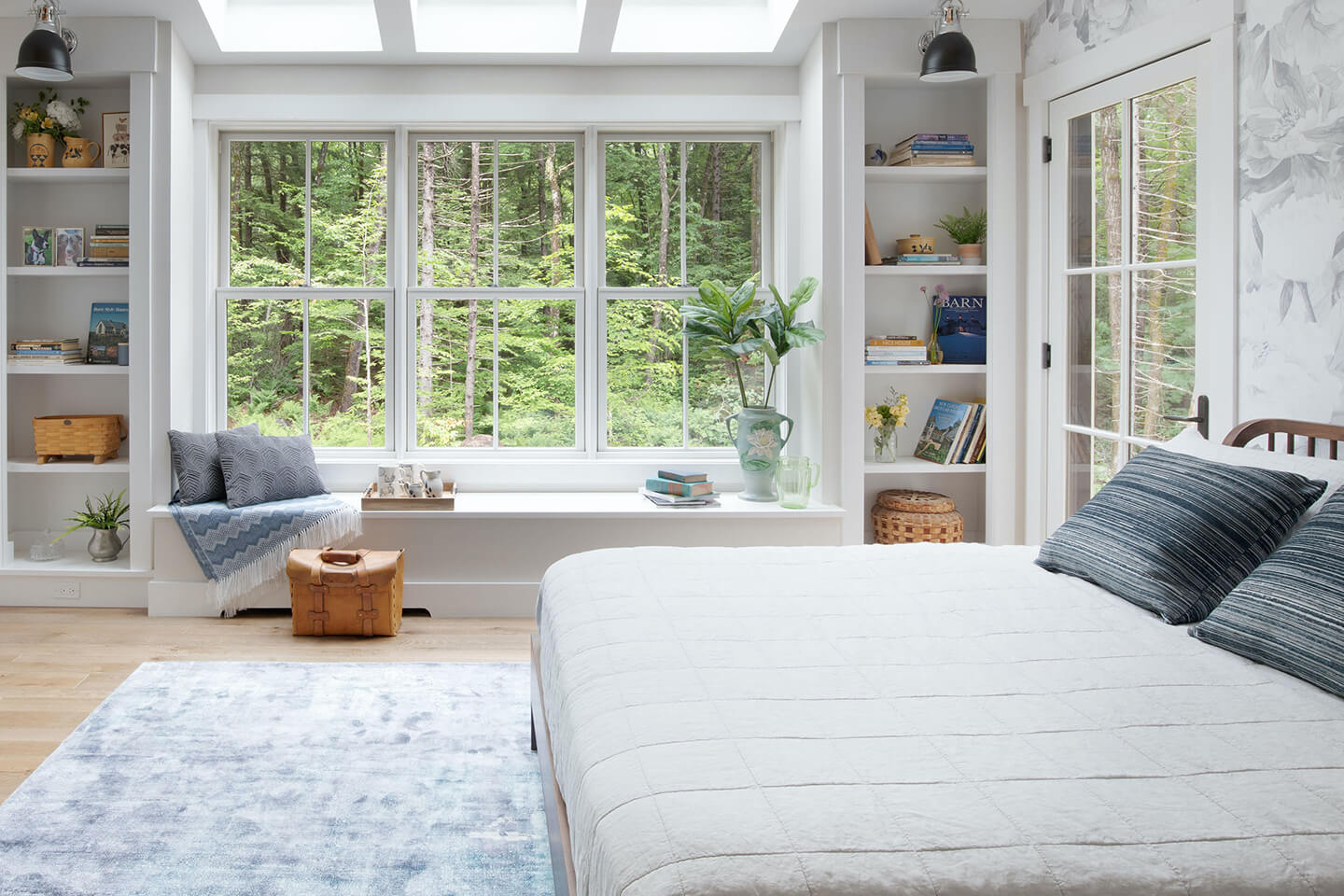 A bedroom with Marvin double hung windows and a window seat.