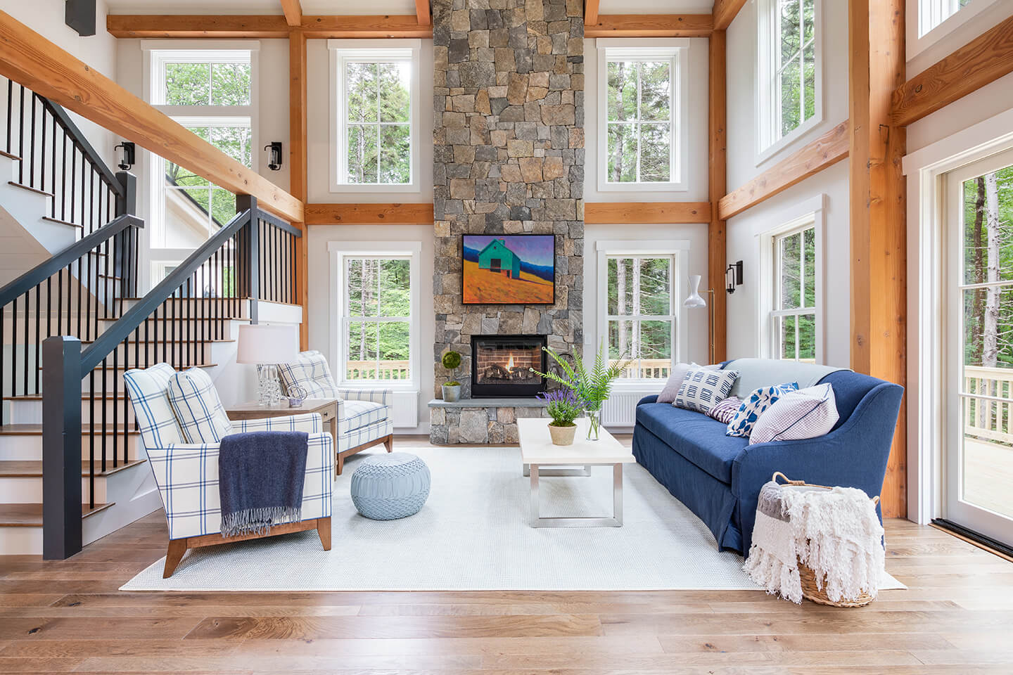 Living room featuring stone fireplace and Marvin double hung windows.