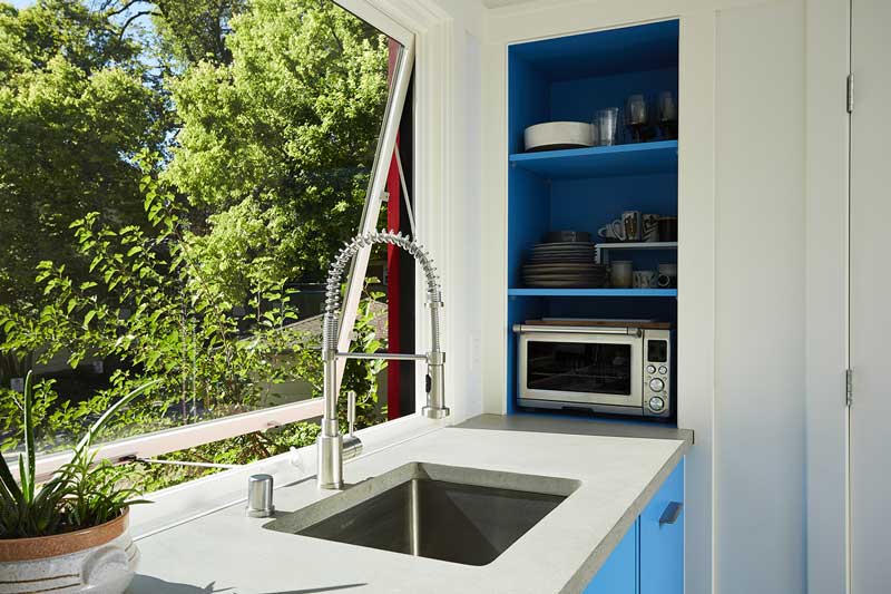 A Marvin Ultimate Awning window open above the sink inside a contemporary tiny house in Minneapolis, Minnesota.