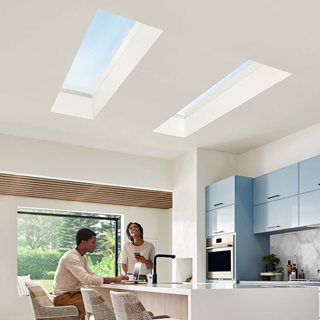 Family in kitchen with Marvin Awaken skylight windows