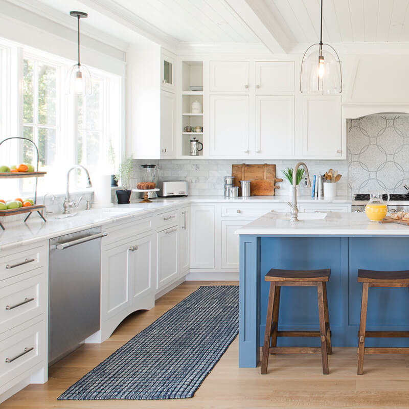 The light-filled kitchen in a Dutch Colonial home in Westerly, Rhode Island, featuring Marvin windows.