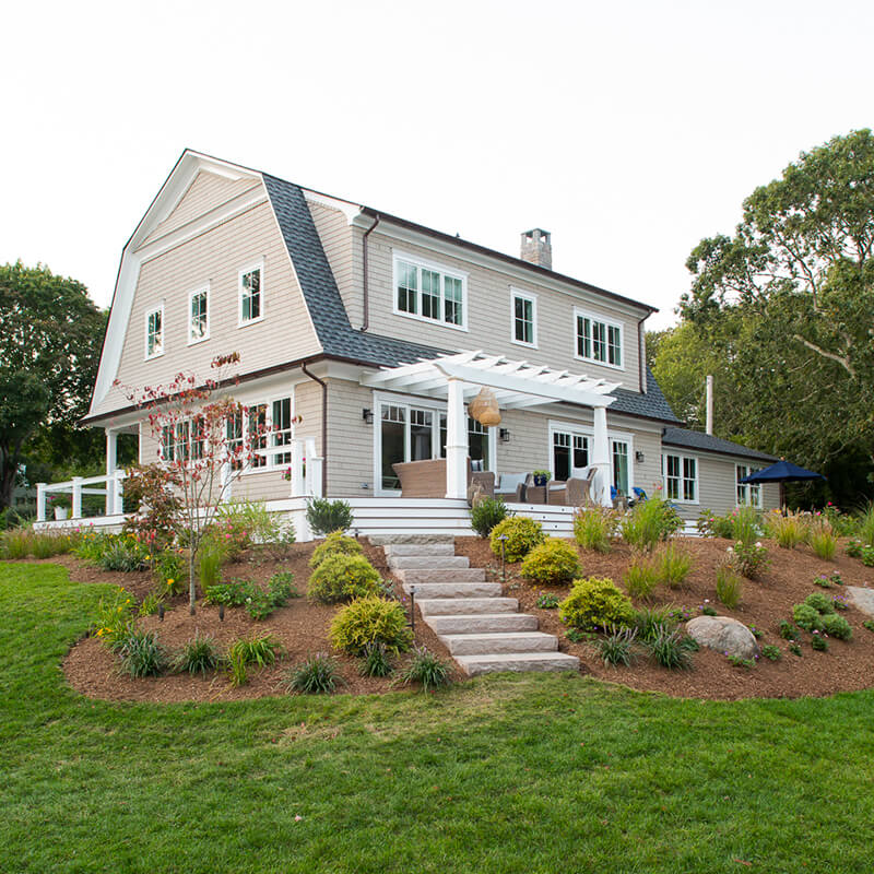 Exterior shot of a Dutch Colonial home in Westerly, Rhode Island, remodeled by This Old House.