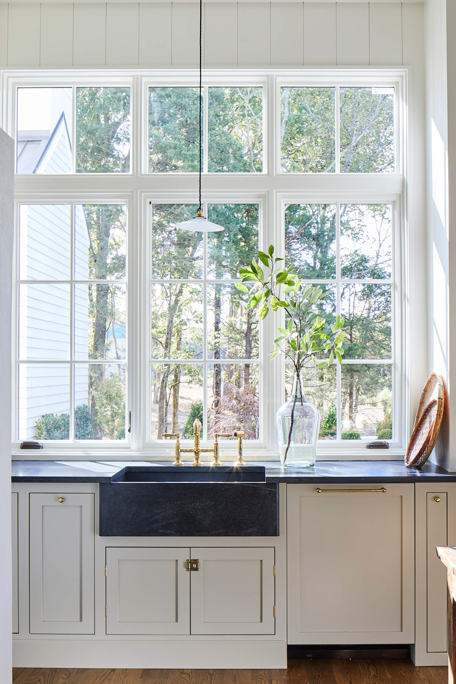 A bright kitchen featuring Marvin Signature Ultimate casement windows looking out to the backyard.