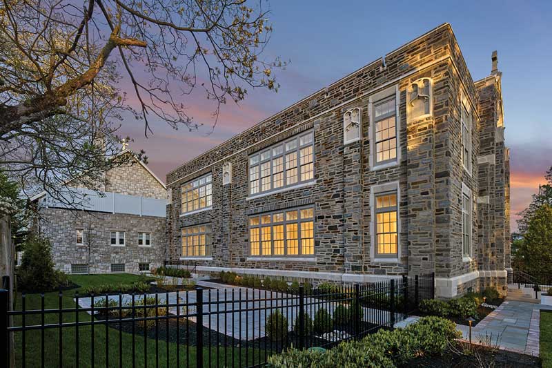 An exterior photo of a historic school in a suburb of Philadelphia that has been converted to luxury condos.