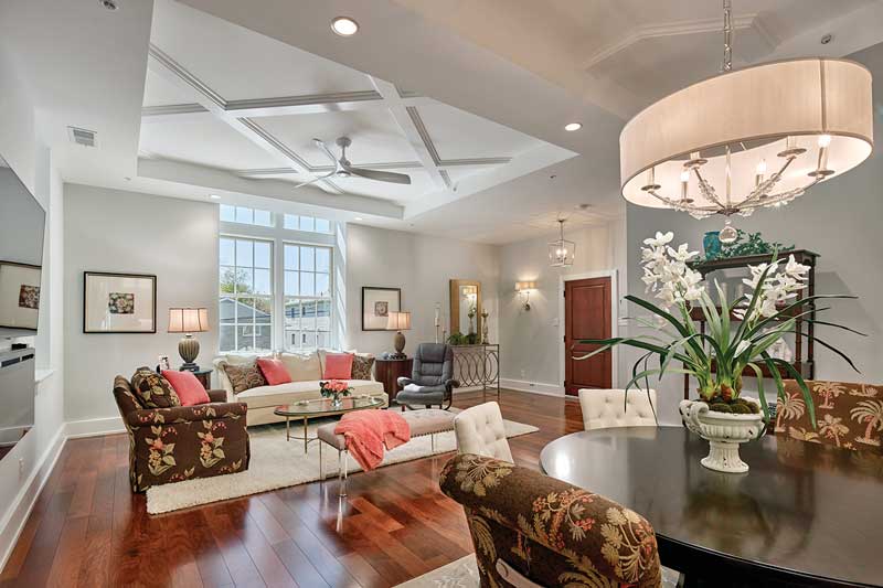 A contemporary living room in a historic school turned luxury condos, featuring Marvin Elevate double hung windows.