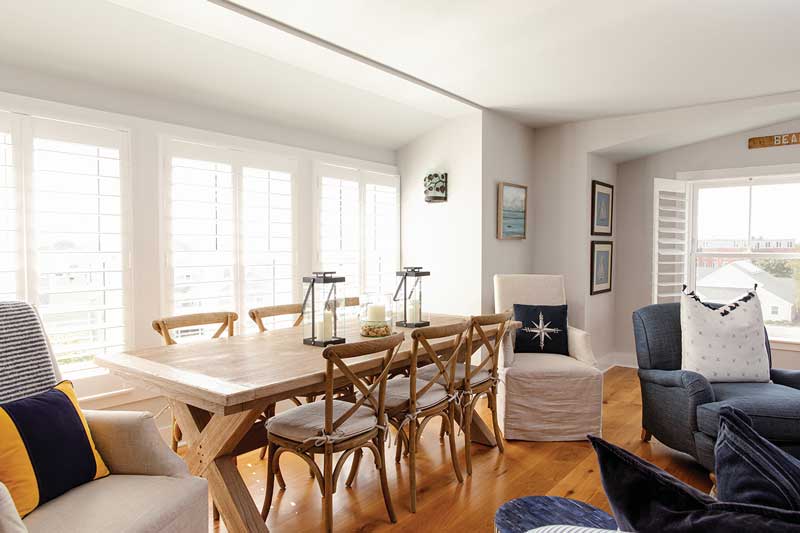 A dining area next to the living room in a condo at The Standard, featuring Marvin Ultimate Double Hung G2 windows.