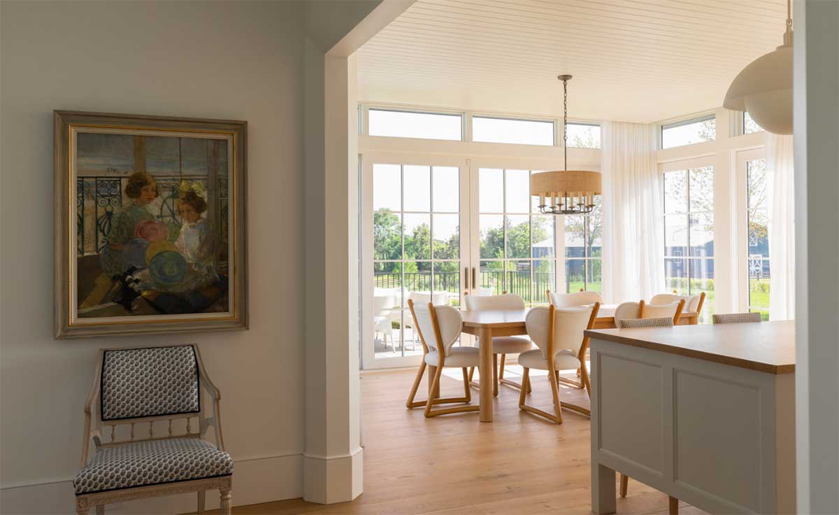 The dining room inside a Swedish traditional home in Media, Minnesota, featuring a Marvin Ultimate Sliding French door and direct glaze windows.