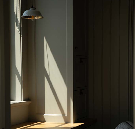 Natural light casting a shadow through a Marvin Ultimate window in a Swedish traditional home in Medina, Minnesota.