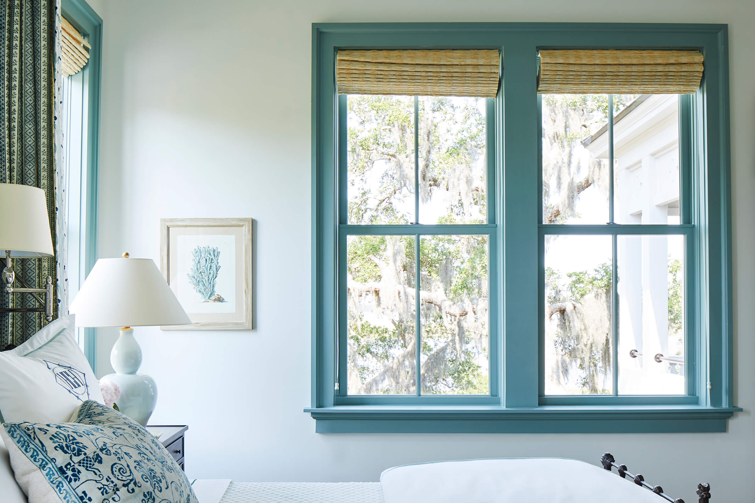 A bedroom with blue interior Marvin windows in the 2019 Southern Living Showhouse on Amelia Island.