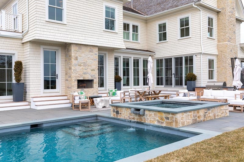 The back of a home with pool, hot tub, and Marvin Elevate windows and doors.