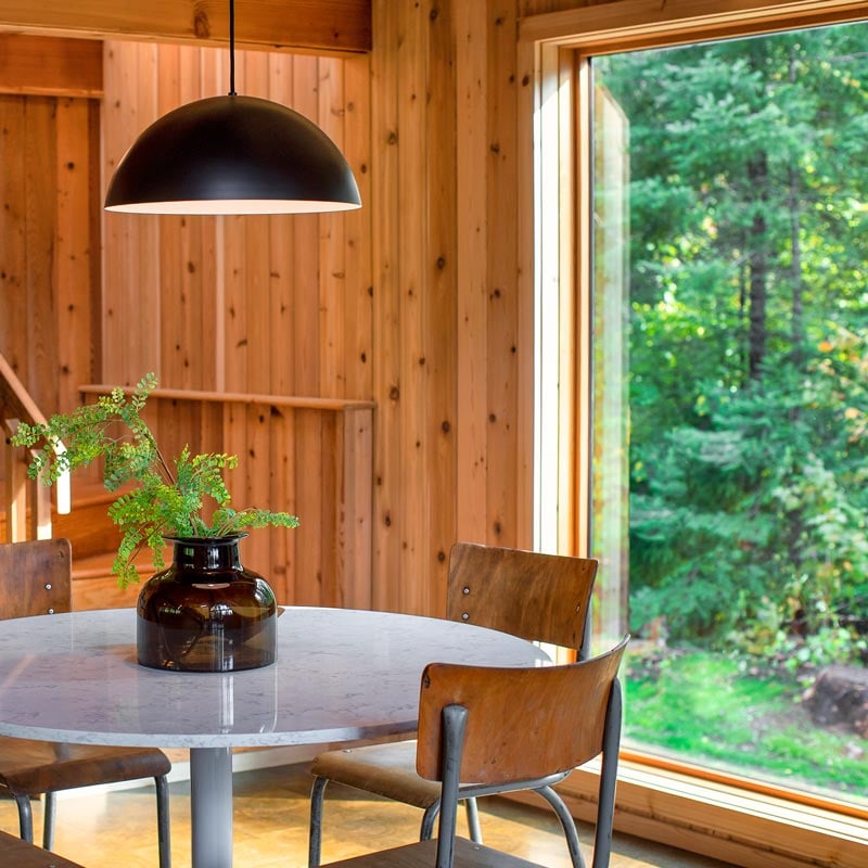 The dining room in Melissa Coleman’s The Minne Stuga Northwoods cabin, featuring a Marvin Ultimate Picture window.