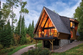 Exterior photo of The Minne Stuga, a cabin in the Northwoods of Minnesota, featuring Marvin Ultimate windows and doors, Marvin Skycove and two Marvin Awaken Skylights