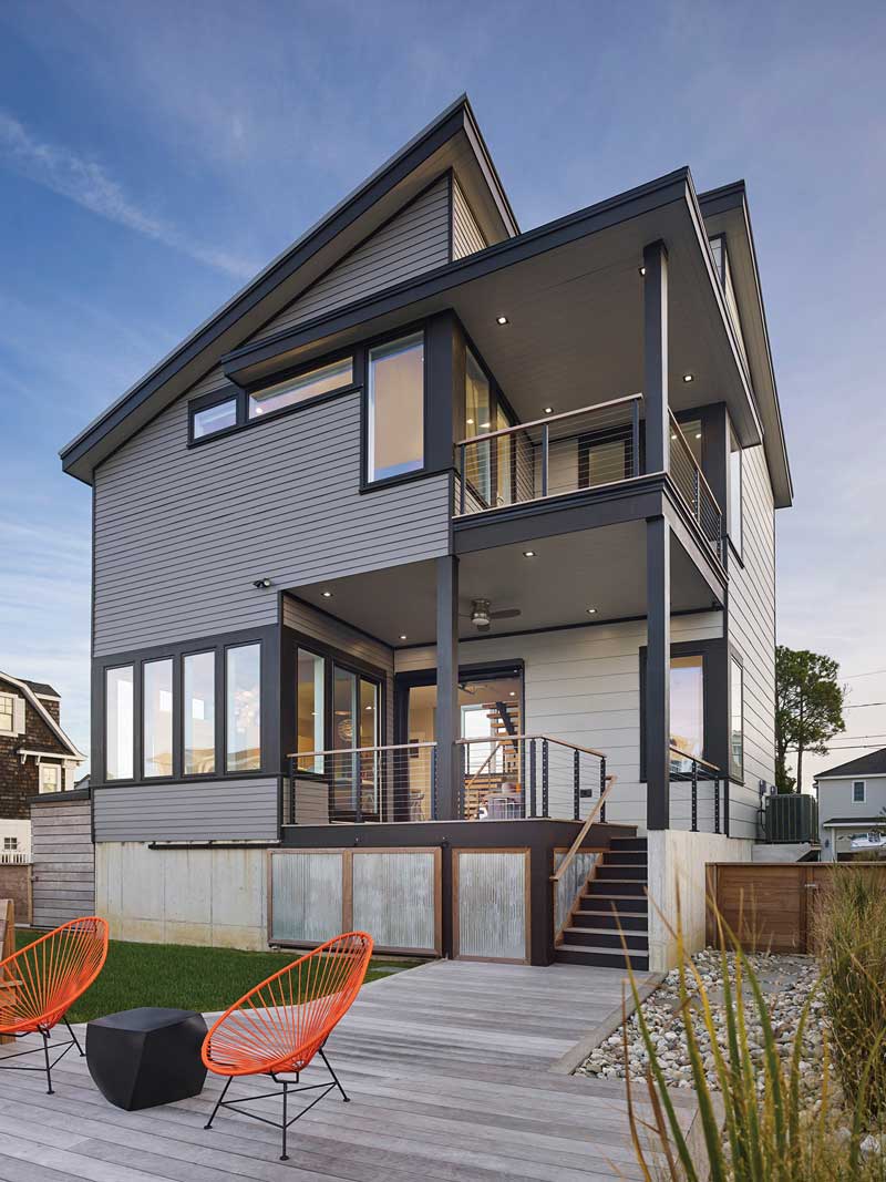 The back of a modern beach house featuring Marvin Elevate Casement windows.