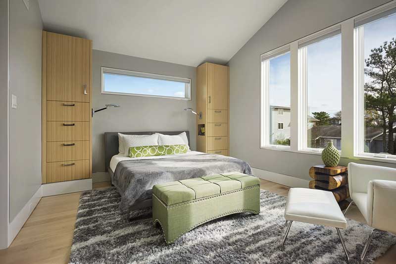 A bedroom in a modern beach house featuring Marvin Elevate Casement windows.