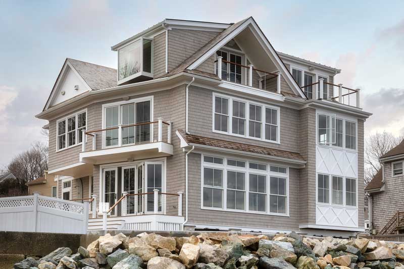 A coastal home facing Kimball Beach in Massachusetts, featuring Marvin Elevate windows and doors.