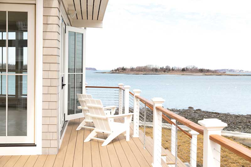 The deck of a coastal home facing Kimball Beach in Massachusetts, featuring Marvin Elevate windows and doors.