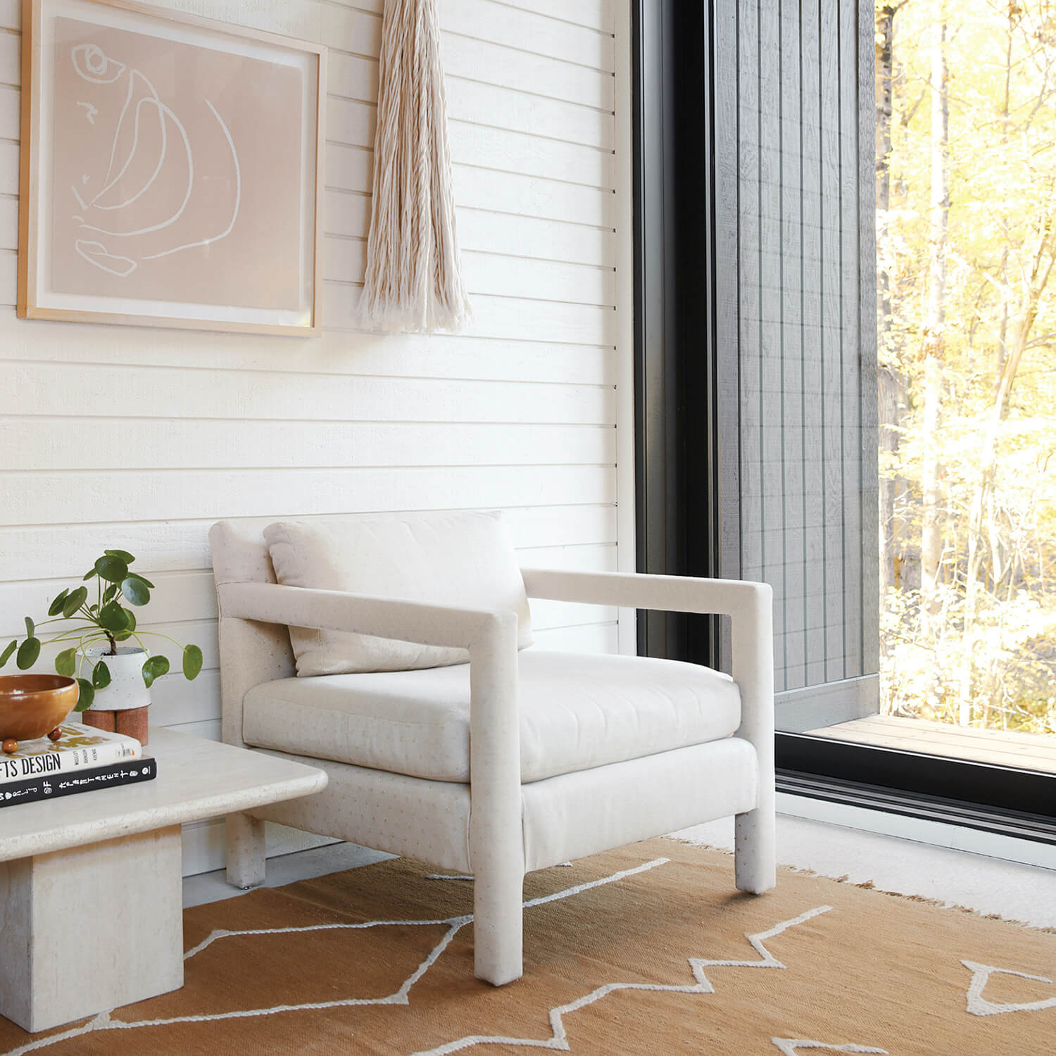 A cozy spot near a window in Sarah Sherman Samuel’s modern home office space.