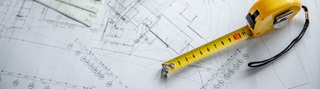 Tape measure on top of architectural blueprint