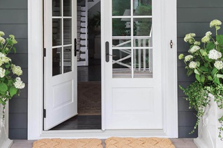 Exterior View Of House Entrance With An Open Signature Ultimate Swinging French Door