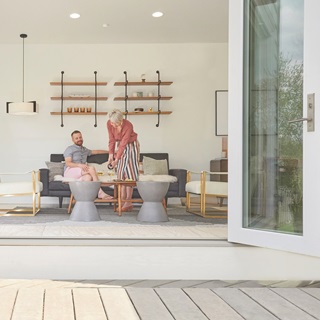 People Sitting In Porch With Signature Ultimate Bi-Fold Door