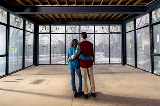 Man and woman looking out new home with Marcin windows