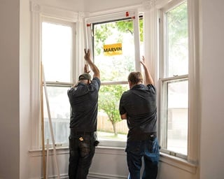 2 Men installing Double Hung Marvin Windows