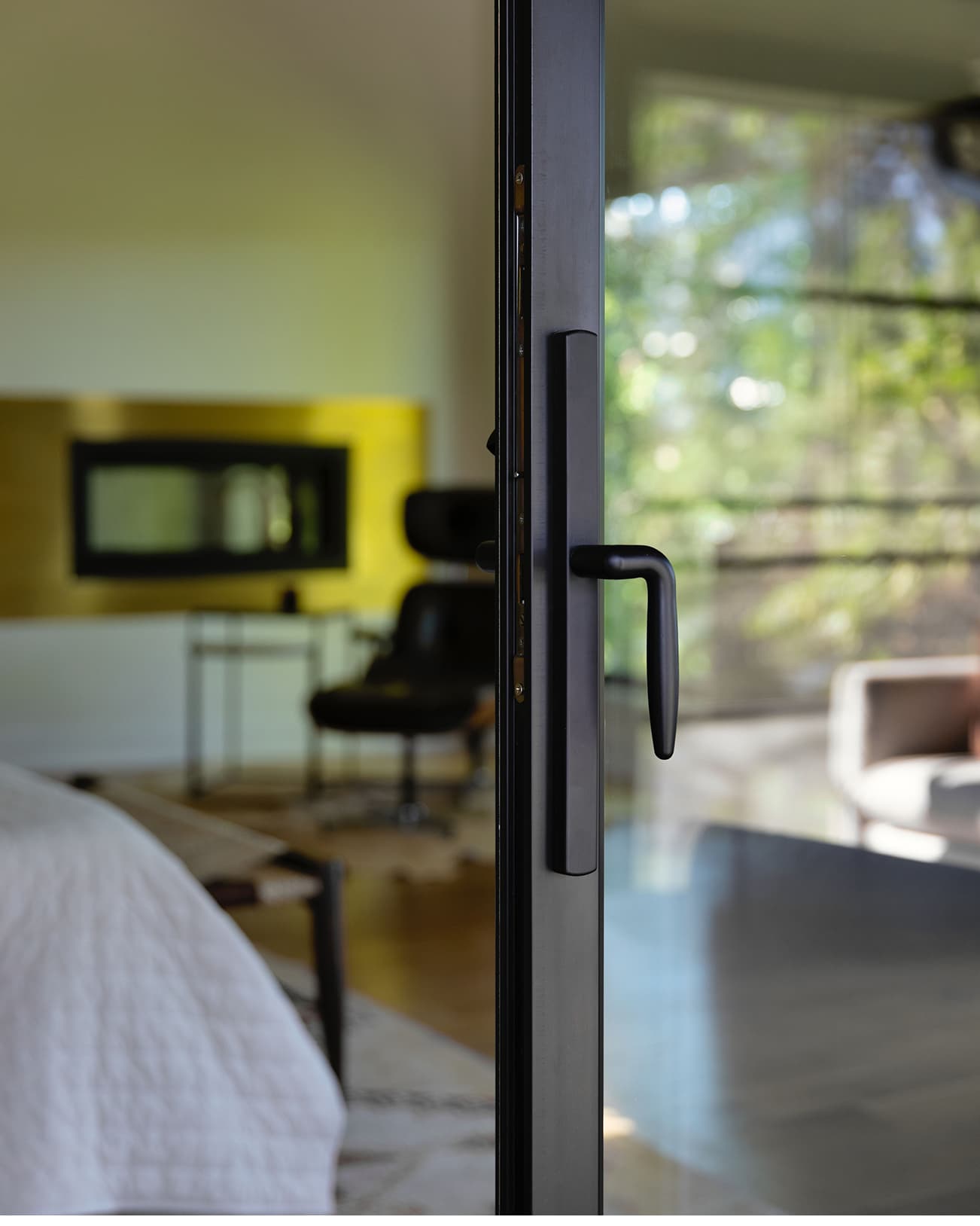 Close up exterior view of a black Marvin Elevate Sliding Door handle on an opened door.