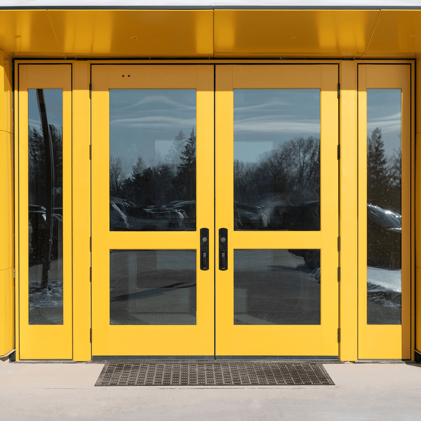 Exterior view of a yellow Marvin Ultimate Commercial Door.